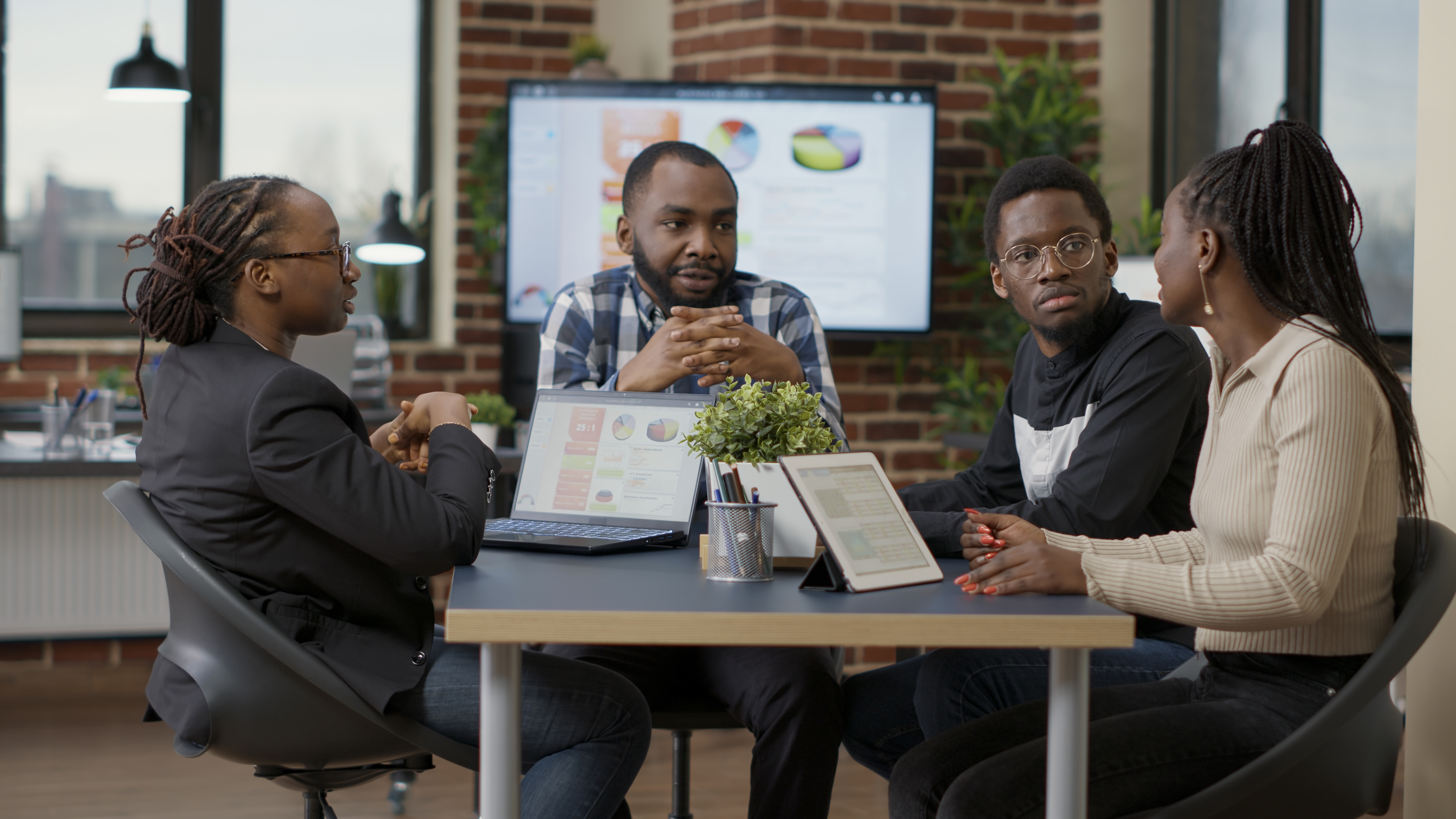 Team of african american businesspeople meeting in boardroom office to discuss strategy and work plan, creating financial project with statistics. Colleagues doing teamwork to analyze sales data.